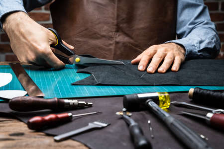 Shoemaker Working With Leather At Tailoring Workshop