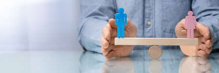 Gender Equality Concept. Male And Male Balancing On Seesawの写真素材