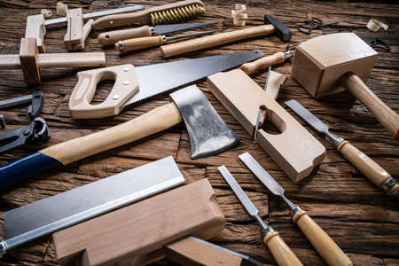 Various Carpenter Tools From Toolkit Laying On Desk