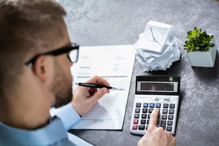 Accountant Calculating Finances. Over The Shoulder Viewの写真素材