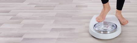 Close-up Of A Human Foot Stepping On Weighing Scale