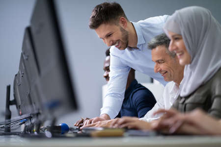 Young Businessman Helping His Colleagues In The Work Of Officeの写真素材