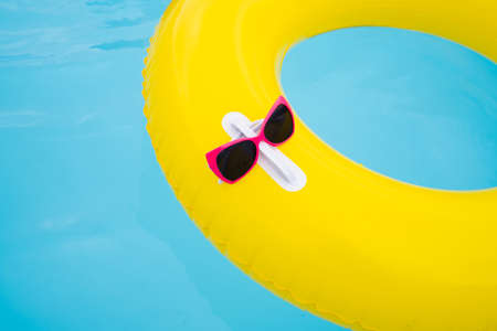 Sunglasses Attached To Ring In Swimming Pool