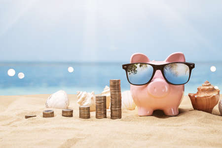 Pink Piggy Bank Near Growing Coin Stacksの写真素材