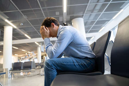 Flight Delay And Cancellation. Upset Man In Airport. の写真素材