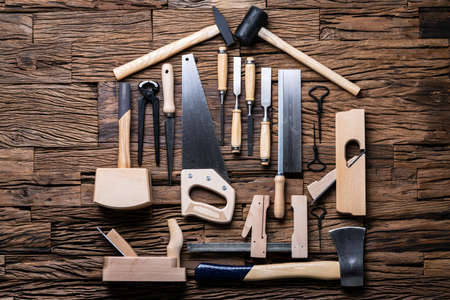 Various Carpenter Tools In House Shape Laying On Deskの写真素材