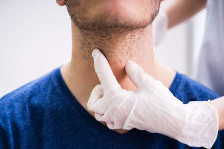Doctor Performing Physical Exam Palpation Of The Thyroid Gland