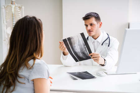 Doctor Having Discussion With Patient About Feet X-ray
