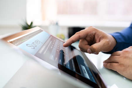 Businessperson Filling Online Survey Form On Digital Laptop