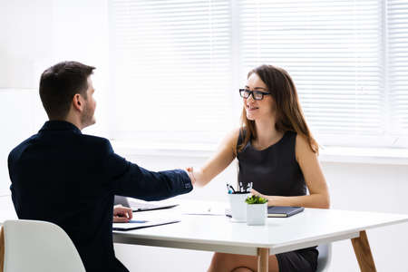 Two Successful African American Businesspeople Shaking Hands At Officeの写真素材