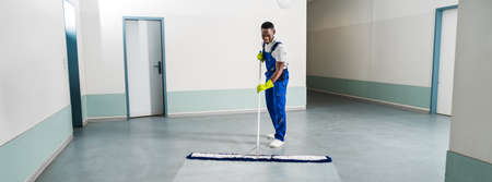 Man With Mop And Wet Floor Sign