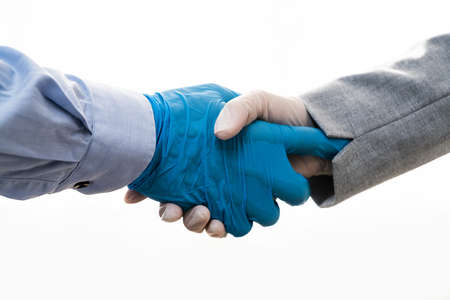 Shaking Hands In Gloves During Coronavirus Pandemicの写真素材