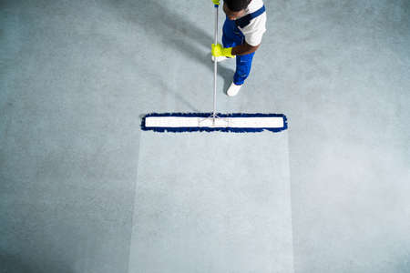 Man With Mop And Wet Floor Signの写真素材