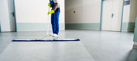Man With Mop And Wet Floor Signの写真素材