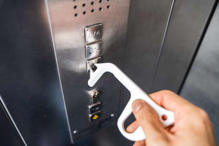 Man Using Contactless Tool To Press Button To Protect From Coronavirus Infection