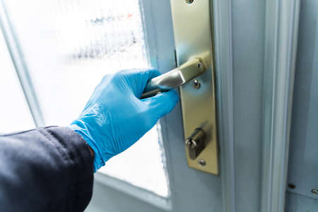 Man Using Gloves To Open Door To Protect From Coronavirus Infectionの写真素材