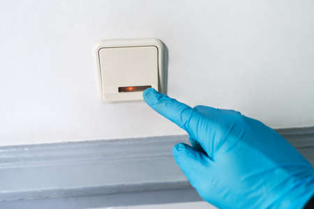 Man Using Gloves To Press Button To Protect From Coronavirus Infection