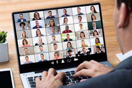 Man Working From Home Having Online Group Videoconference On Laptop