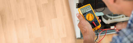 Testing Electric Appliance Using Multimeter To Repair Fridge At Homeの写真素材