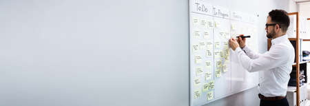 Executive Writing Kanban Plan And Schedule On Whiteboardの写真素材