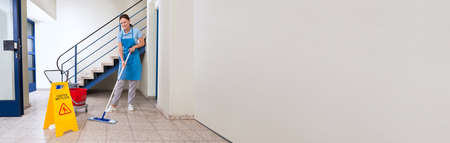 Janitor Cleaning Floor. Cleaning Service Professional At Workplace