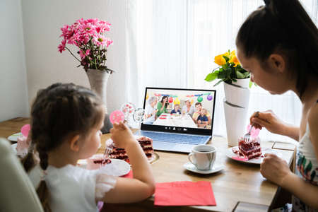 Family Celebrating Birthday Using Video Conference Call