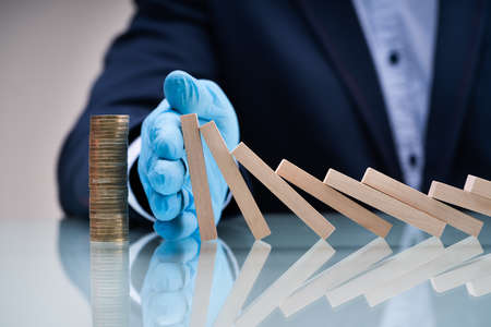 Stopping Domino Falling And Risk Prevention During Coronavirus Crisisの写真素材