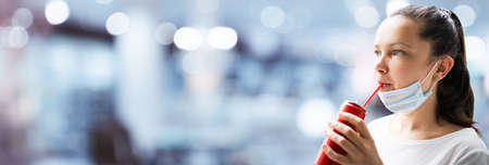 Woman Drinking Soda In Face Mask At Outsideの写真素材