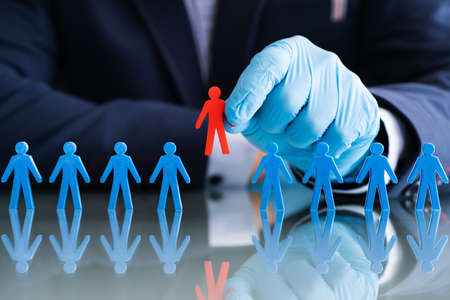Hand In Gloves Selecting Red Candidate Personの写真素材