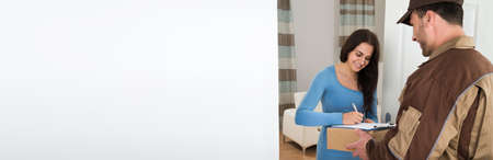 Happy Woman Receiving Package From Delivery Courier Manの写真素材