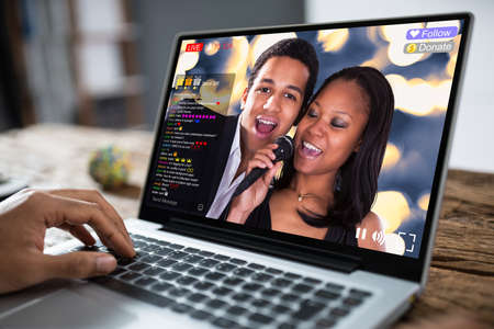 Streaming Live Music Video With Singer On Laptop Computerの写真素材