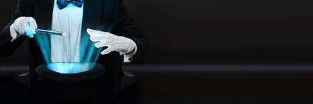 Magician Man Holding Magic Wand Doing Performance With Hatの写真素材