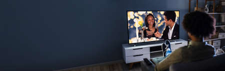 African Man Streaming And Watching Movies On TV