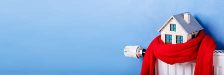 Scarf Around House On Radiator. Home Energy And Temperature Thermostatの写真素材