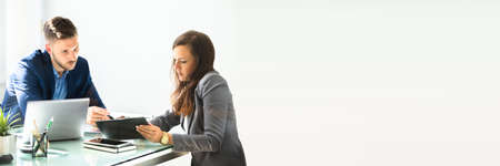 Auditor Or Broker Using Digital Tablet. People Discussing