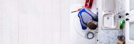 Plumber Cleaning Pipe. Unclog Drain And Sinkの写真素材