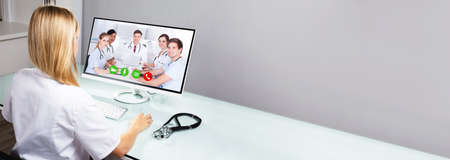 Doctor In Online Video Conference On Computer Screen