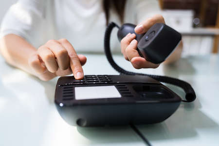 Businesswoman Hand Making Landline Telephone Call Pressing Button
