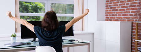 Desk Stretch Exercise. Woman Stretching At Work In Office