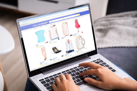 Women Shopping Online On Couch Or Sofa Using Laptopの写真素材