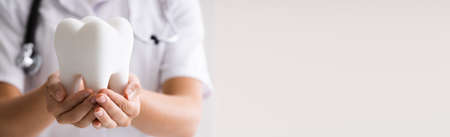 Dentist Woman Doing Cleaning And Whitening Tooth Treatmentの写真素材