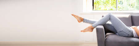 Lazy Woman Sleeping On Couch Or Sofaの写真素材