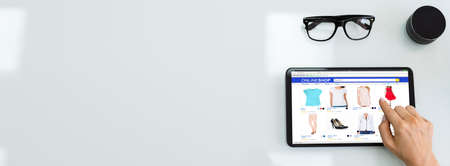 Woman Holding Tablet With Online Ecommerce Shopping Storeの写真素材