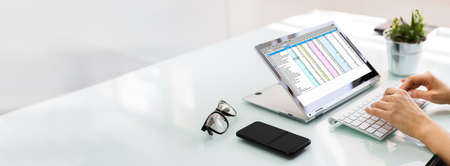 Analyst Employee Working With Spreadsheet On Computer Screenの写真素材