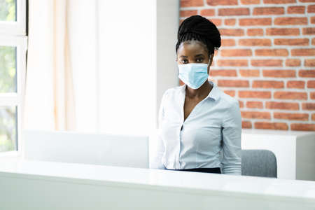 African  Reception Desk Woman Wearing Maskの写真素材