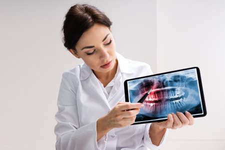 Dentist Using Digital Tablet Technology For Teeth Xrayの写真素材