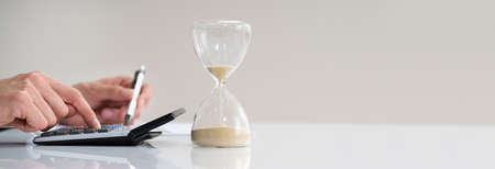 Late Invoice And Hourglass Deadline Working In Office