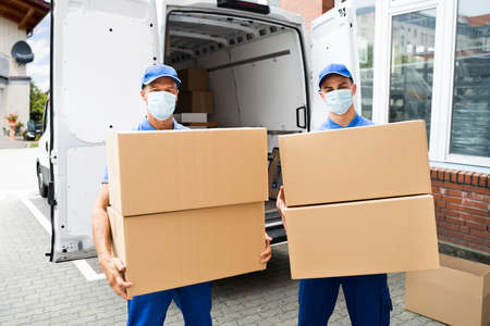 Furniture Move And Removal Using Truck Or Van With Face Maskの写真素材