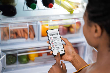 African Consumer Using Mobile Phone Shopping Appの写真素材