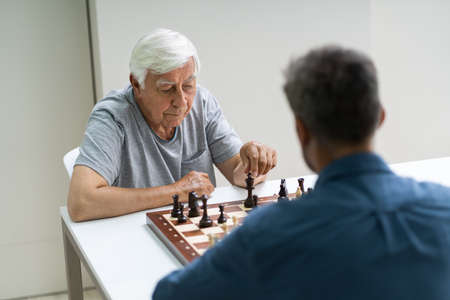 Elderly Senior Playing Chess Table Board Game